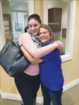 Two woman embracing at Dentistry from the Heart event